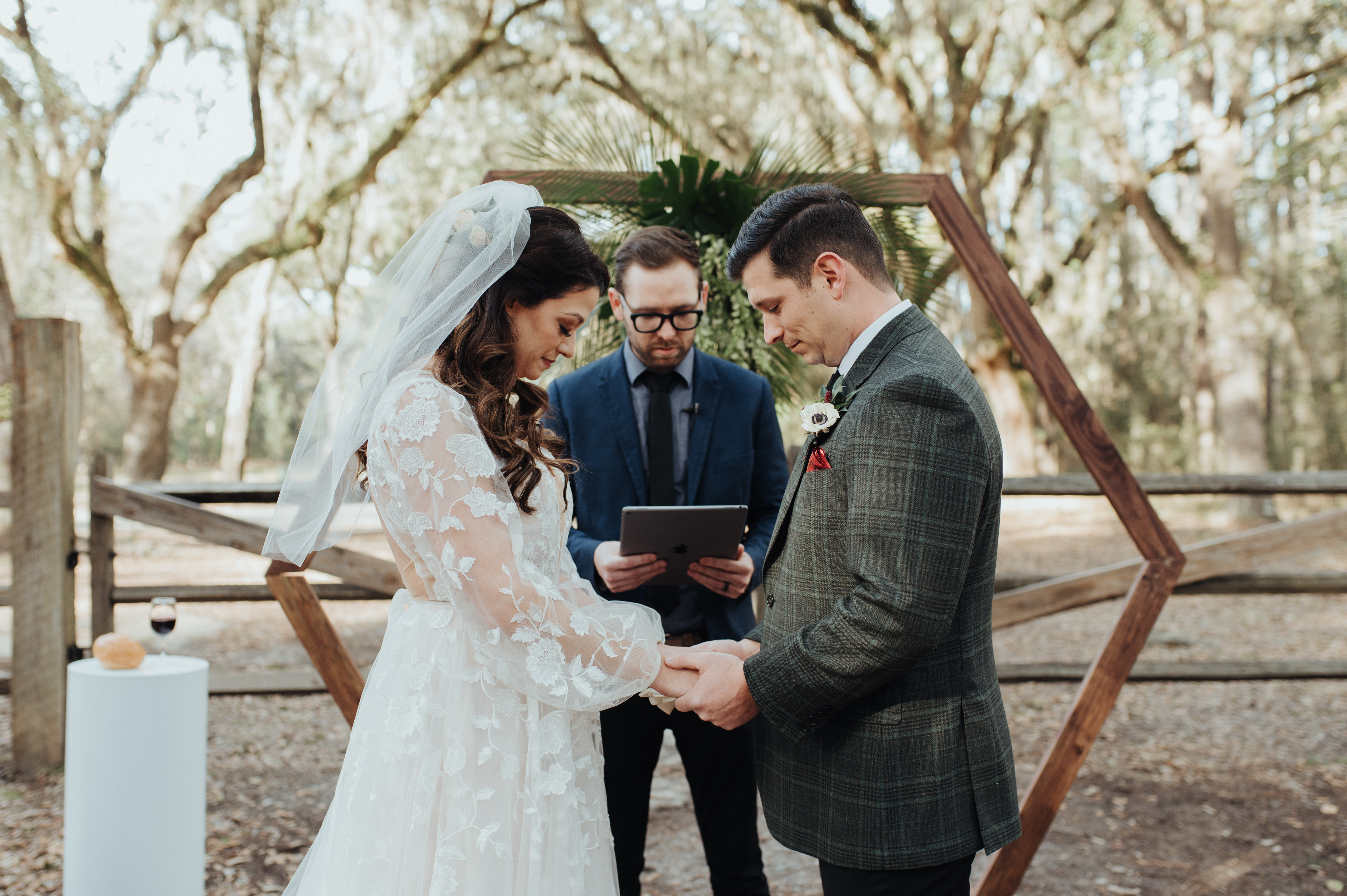 bride and groom saying vows in outdoor ceremony