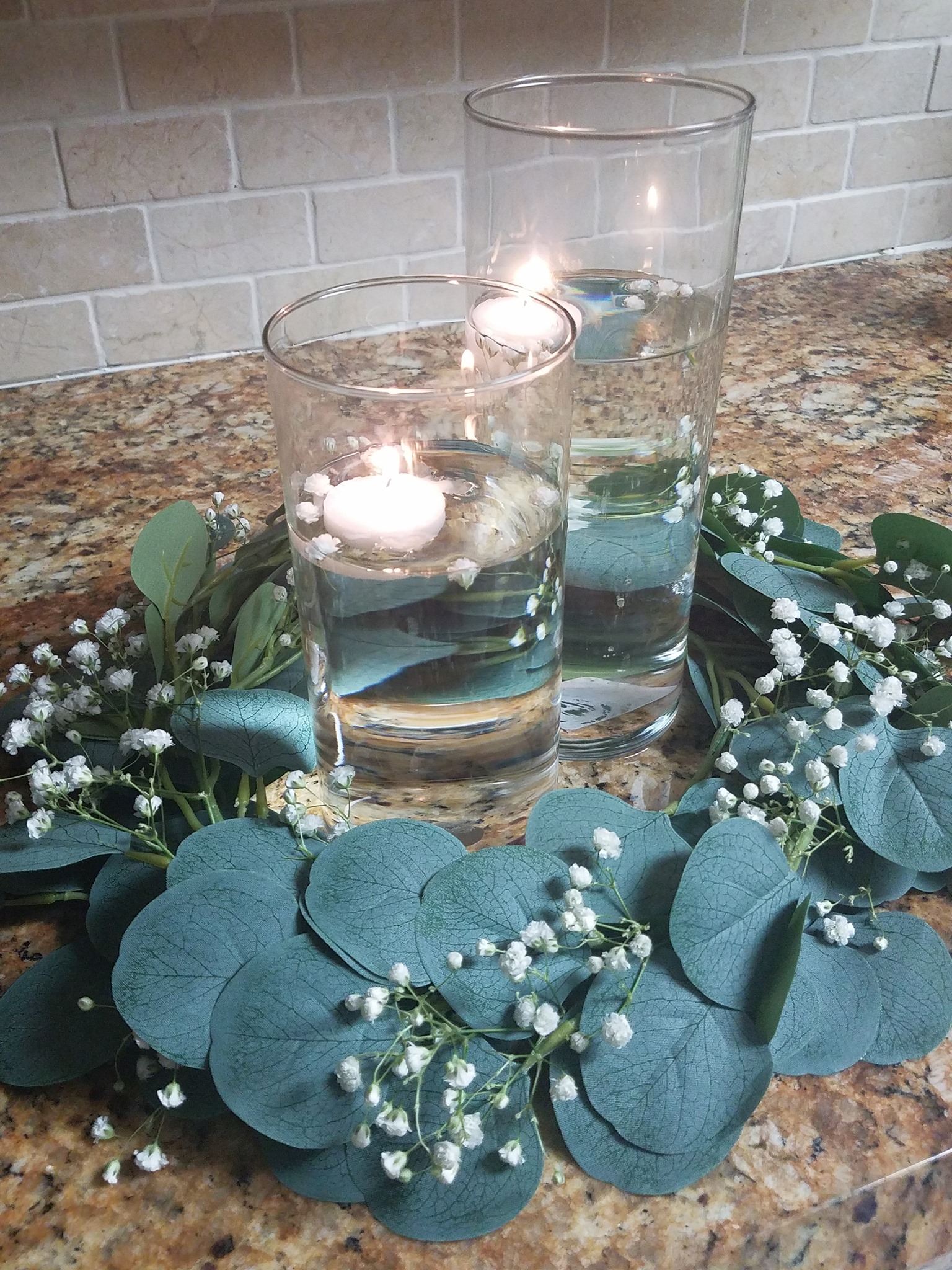 floating candle centerpiece with greenery