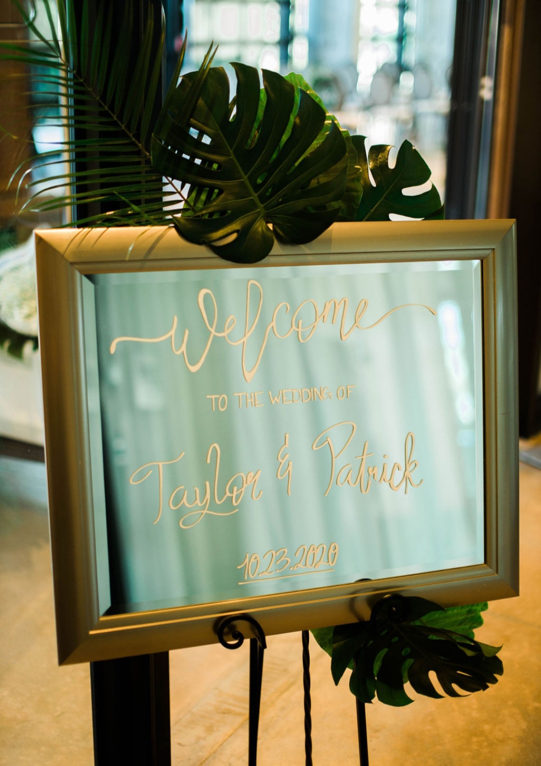 golden mirror with wedding entrance sign printed on it