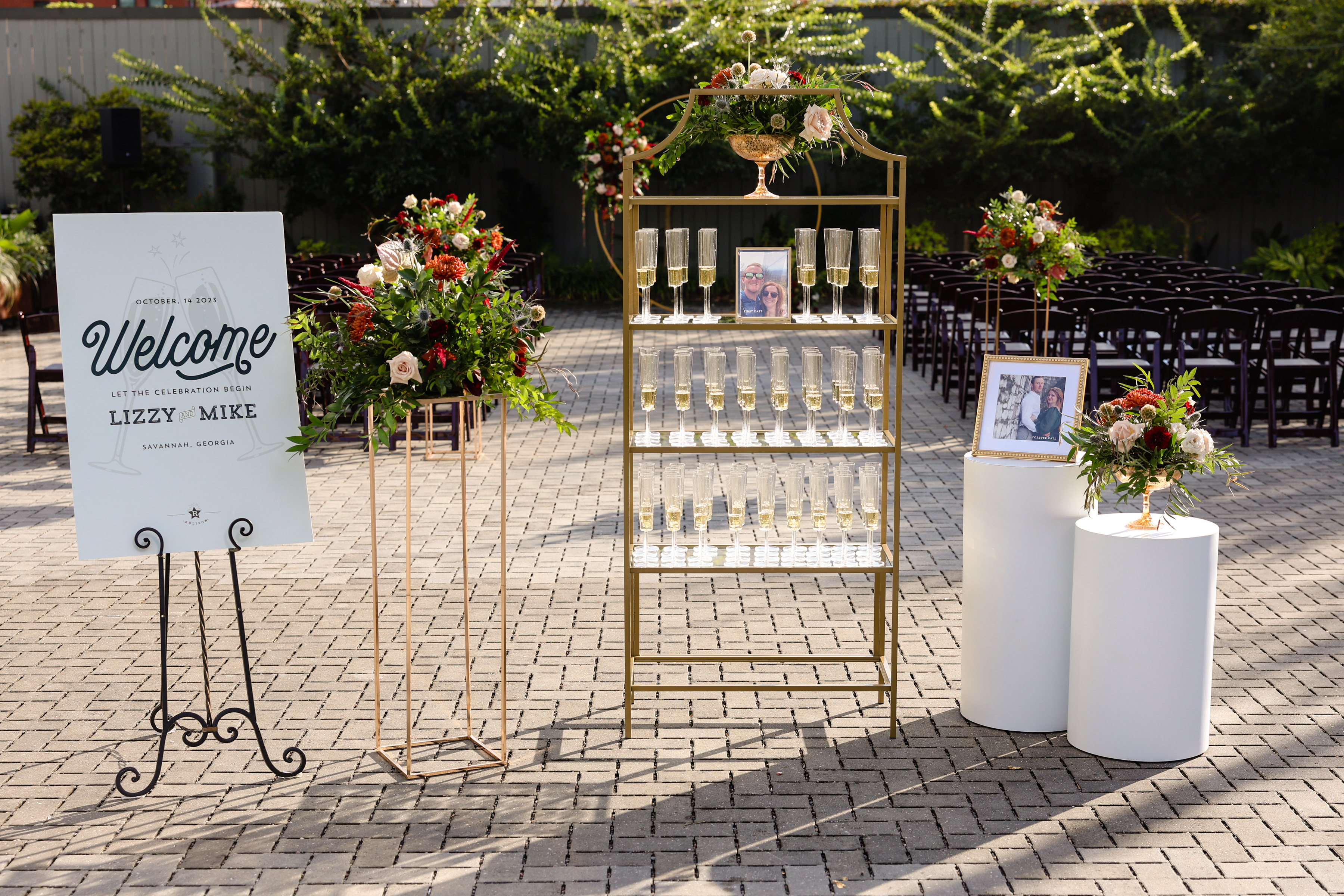 wedding entrance decorations with fall flowers, champagne, and gold accents